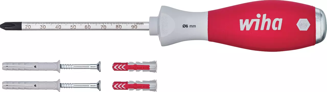 Screwdriver with red handle and metal shaft, next to wall plugs and screws.