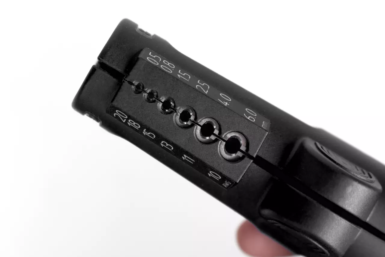 Multifunctional wire stripping tool with measurement markings.