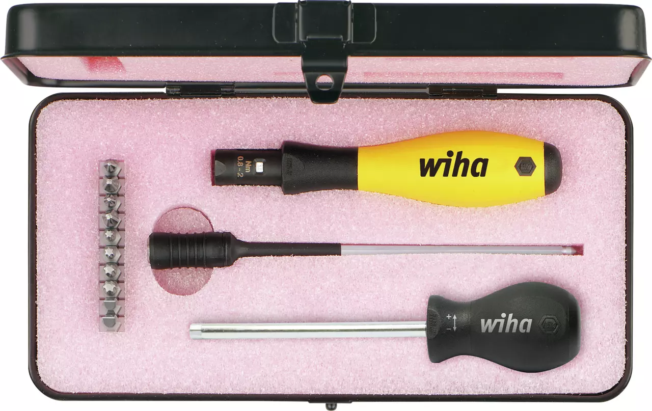 Torque screwdriver set in a black case with pink foam, includes various bits and handles.