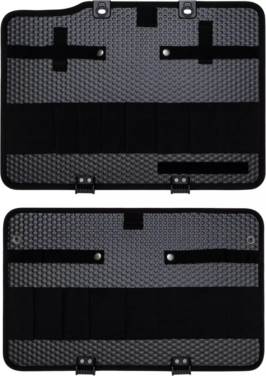Black tool panel with textured surface, straps, and fasteners.