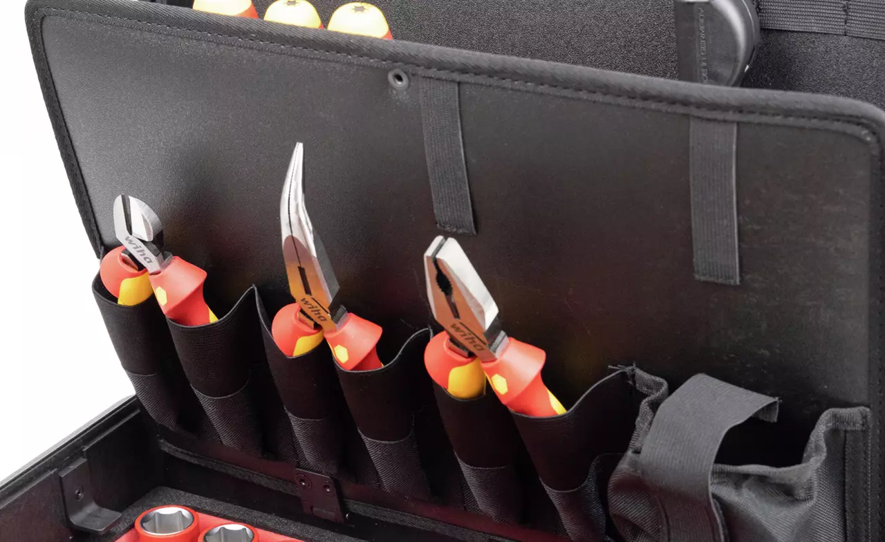 Set of pliers with red and yellow handles in a black tool case