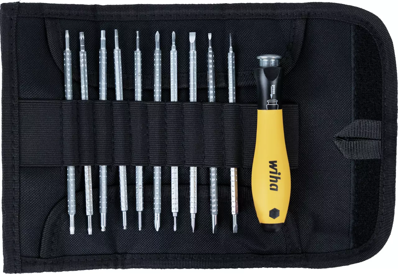 Screwdriver set with multiple bits in a black fabric case, one handle visible.