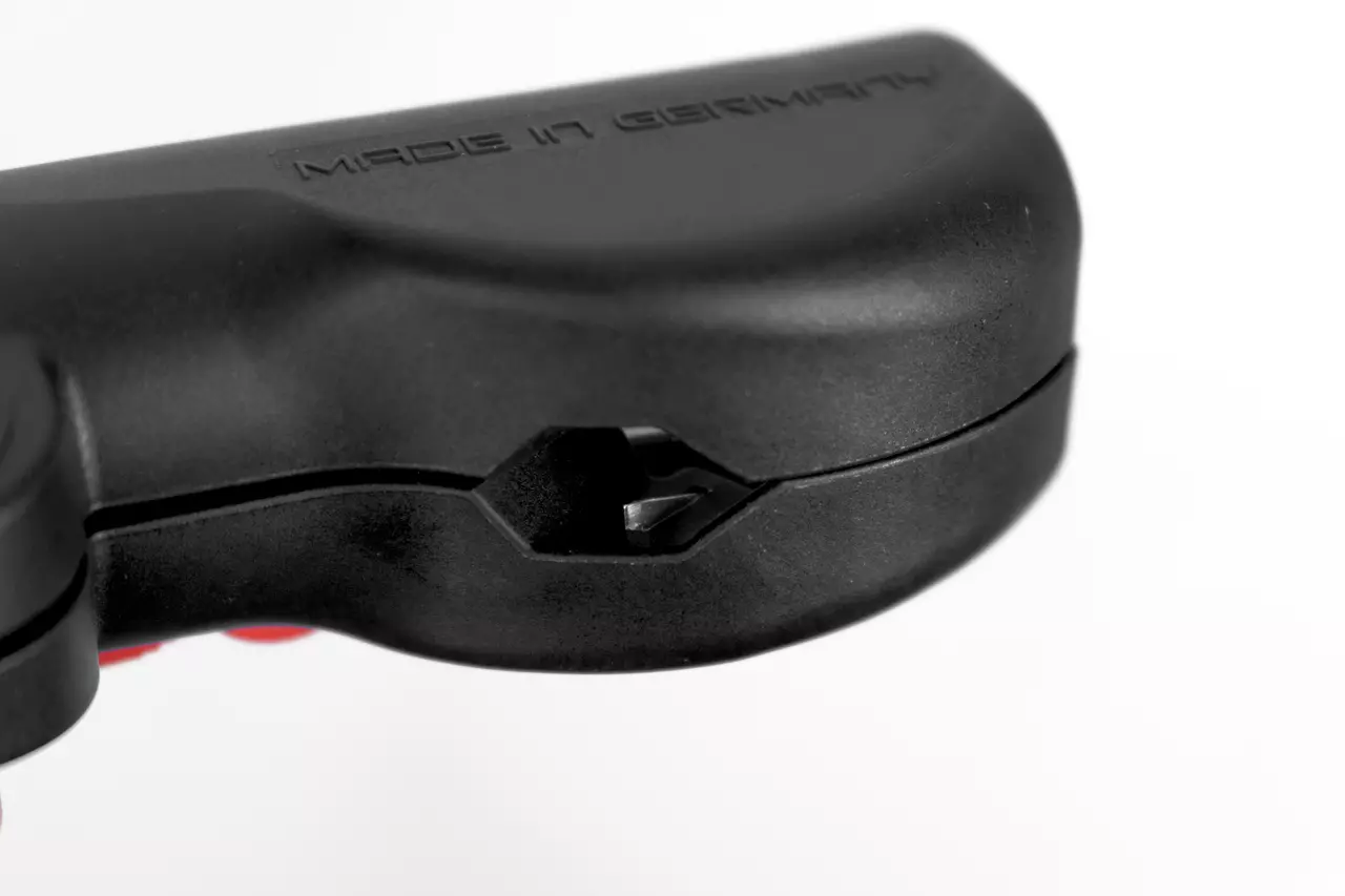 Close-up of a black multifunctional wire stripping tool with "Made in Germany" text.