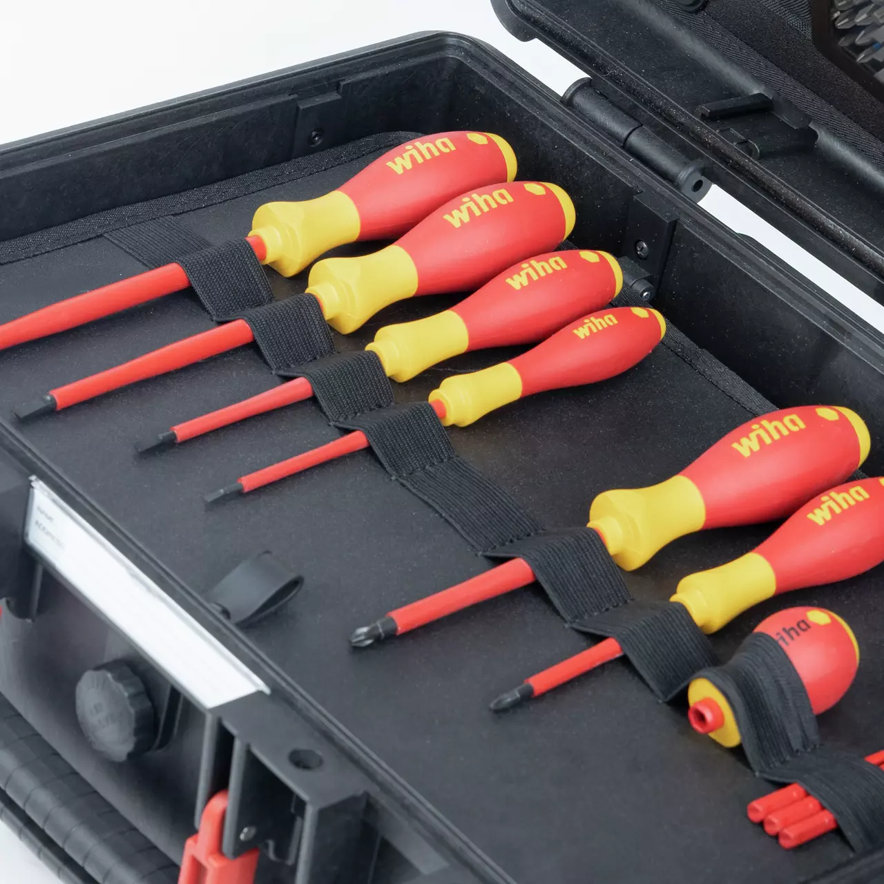 A set of red and yellow electric screwdrivers in a black case.