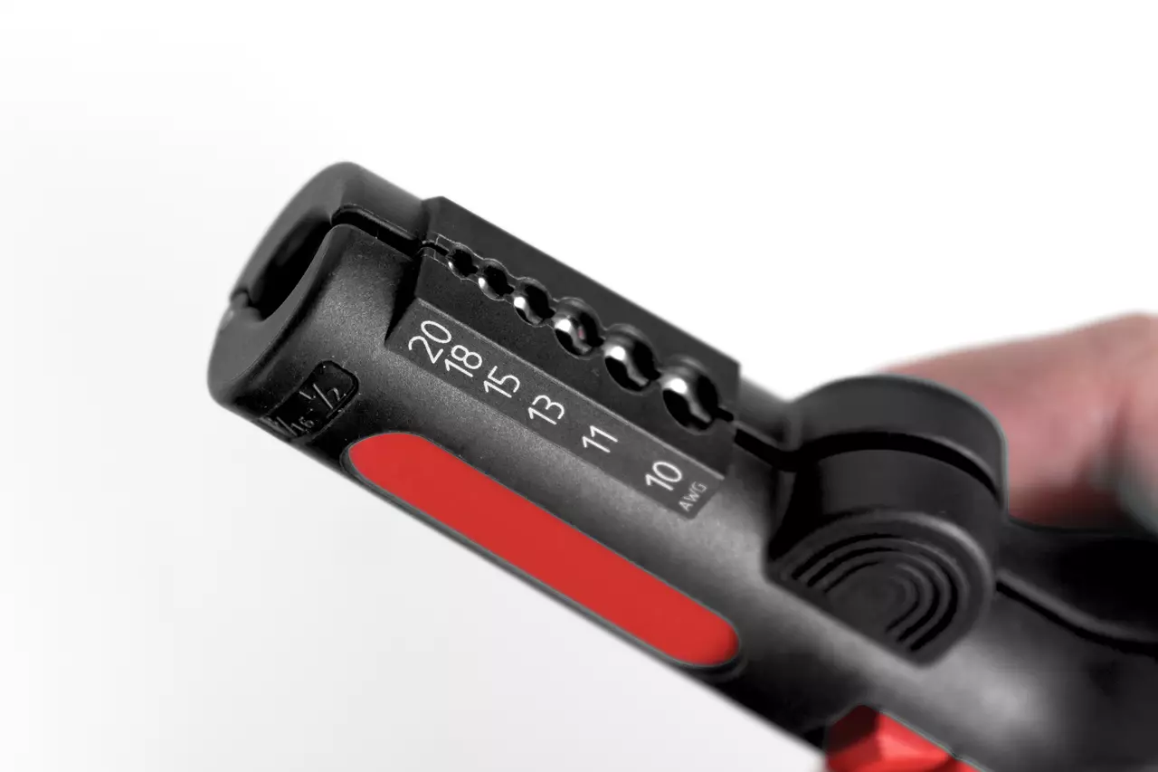 Multifunctional wire stripping tool with red and black design, showing various gauge sizes.