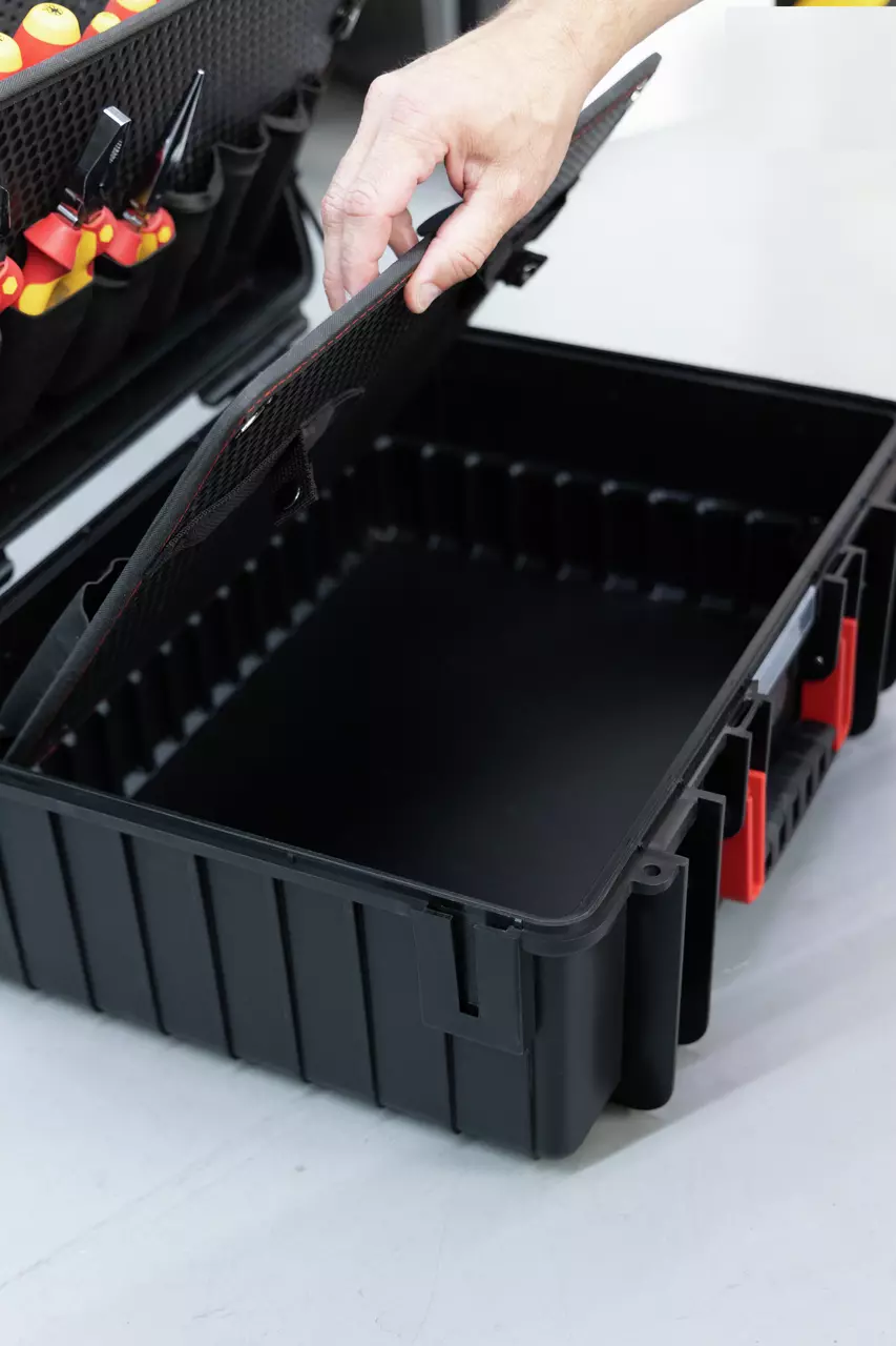A hand opening a black tool case with organized tools inside.