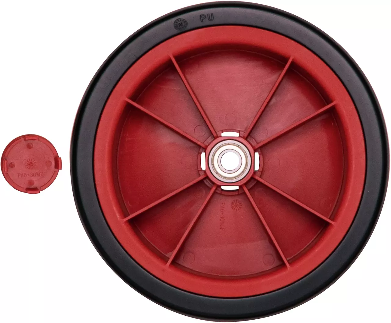 Red and black plastic wheel with a central bearing, shown with a detached red cap.