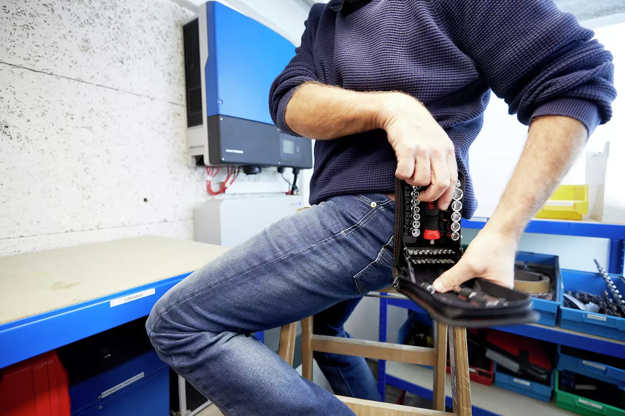 Person holding a socket set in a workshop