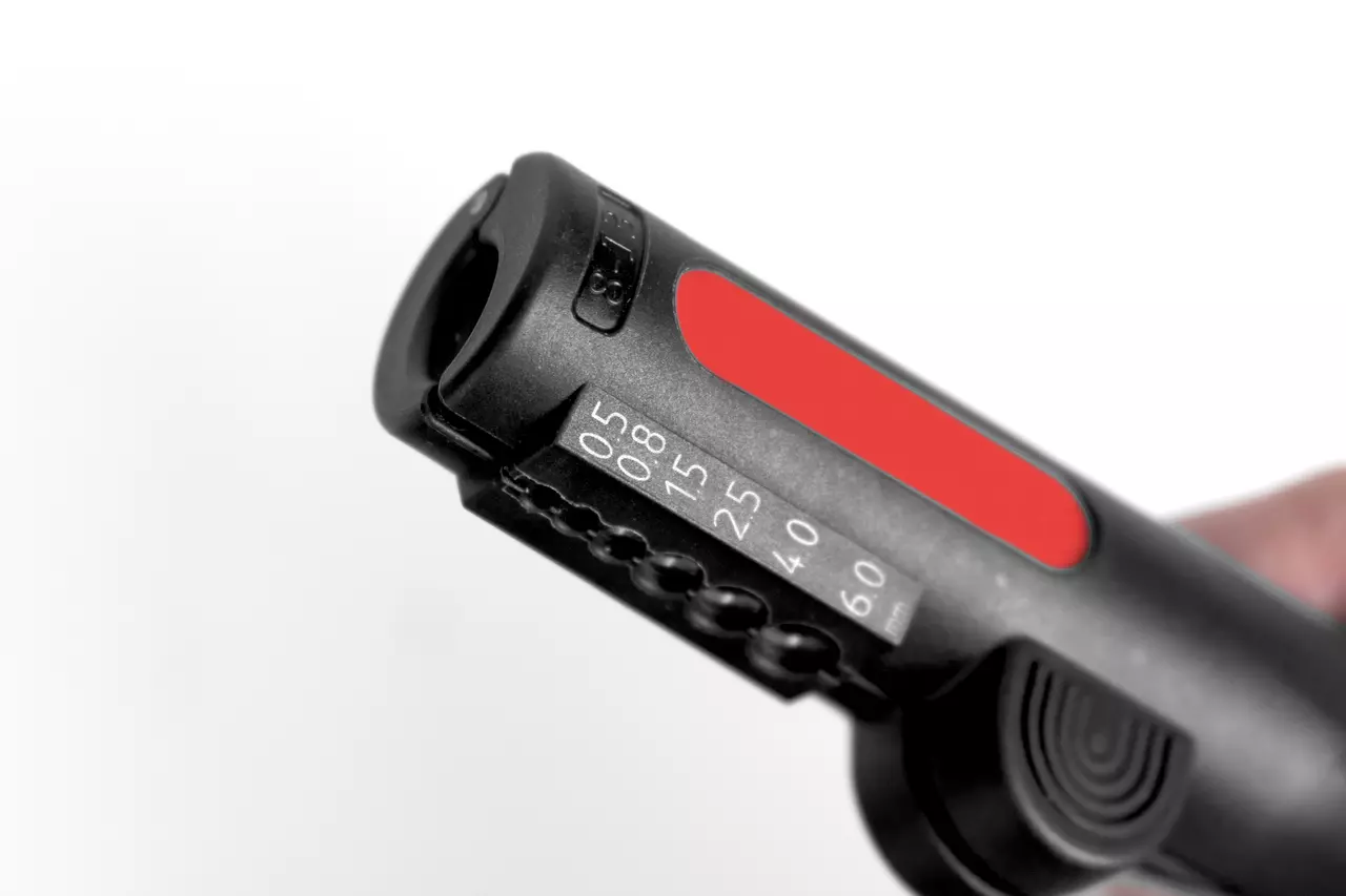 Multifunctional wire stripping tool with red accent and size markings
