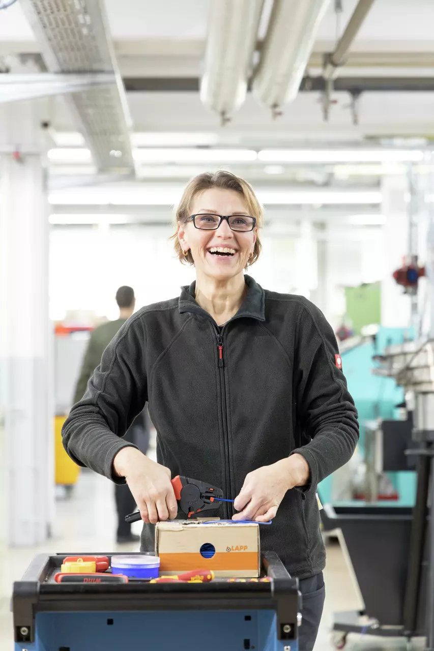Person in workshop using automatic stripping tool