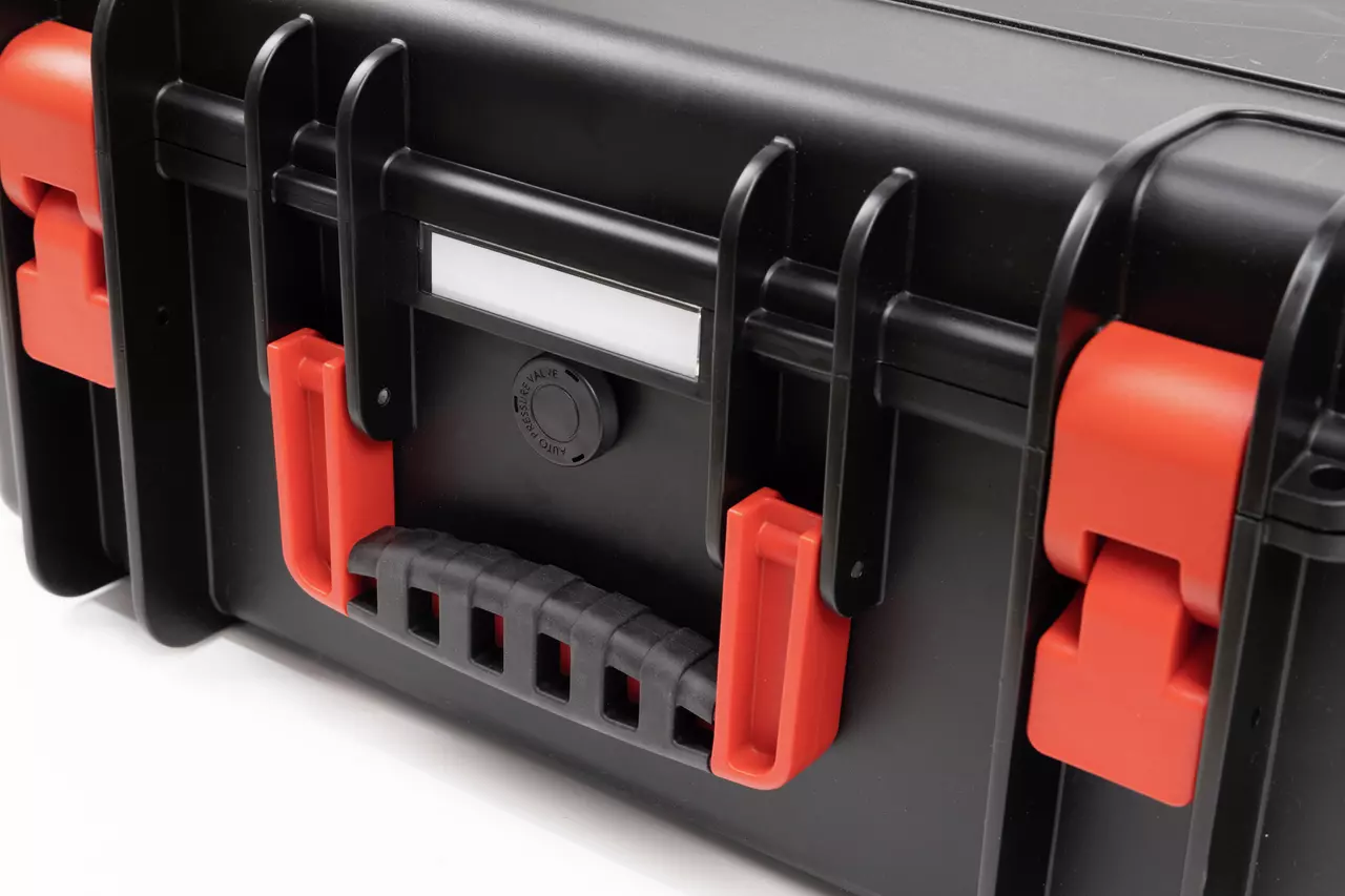 Black hard case with red latches and a black handle