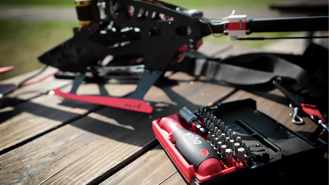 Bit set in open case on table near model helicopter