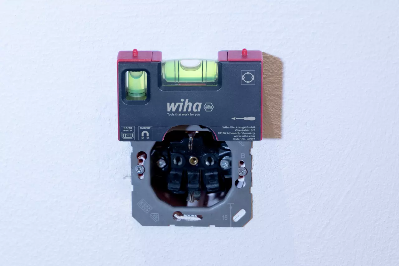 Pocket level on wall with visible socket installation