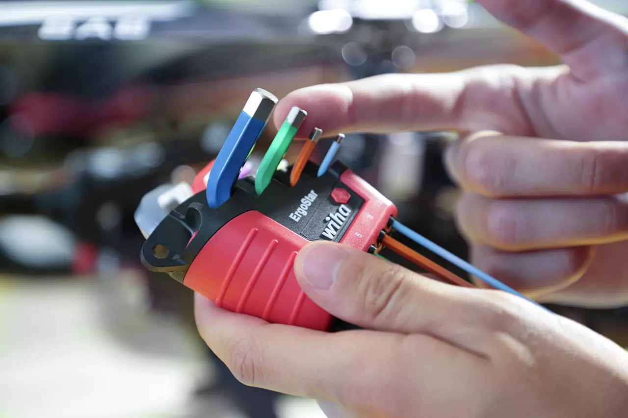 Person holding a red ErgoStar tool set with colorful keys