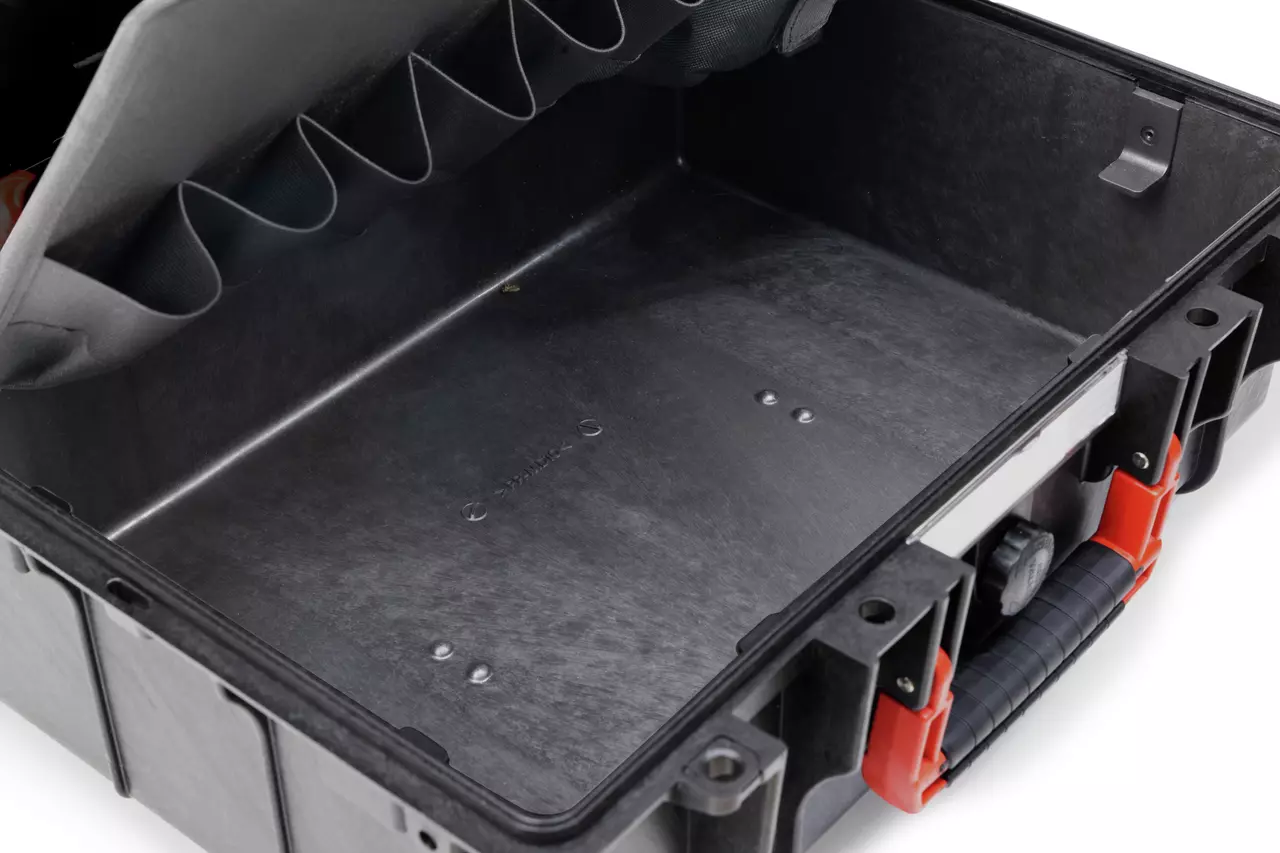 Open tool storage case with black interior and red handle.