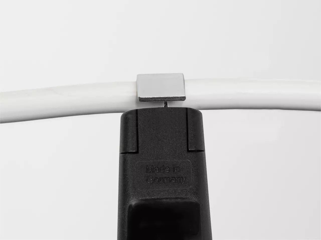 Cable stripping tool on a white cable