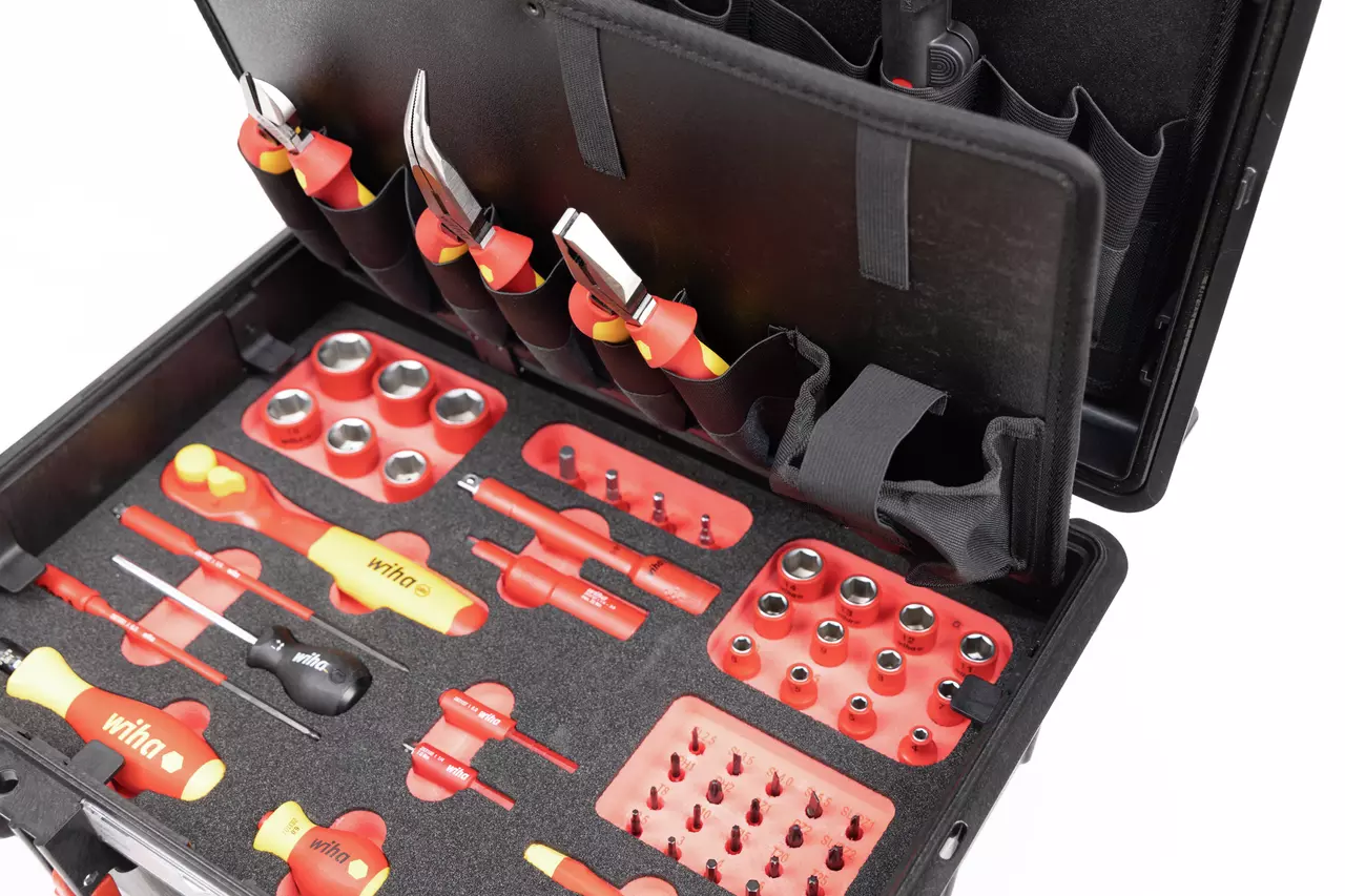 Tool set in a black case with various red and yellow hand tools and sockets.