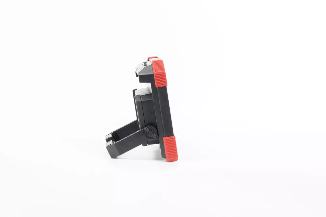Black and red device with a stand, viewed from the side on a white background.