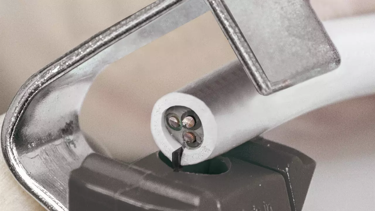 Cable being stripped by a cutting tool