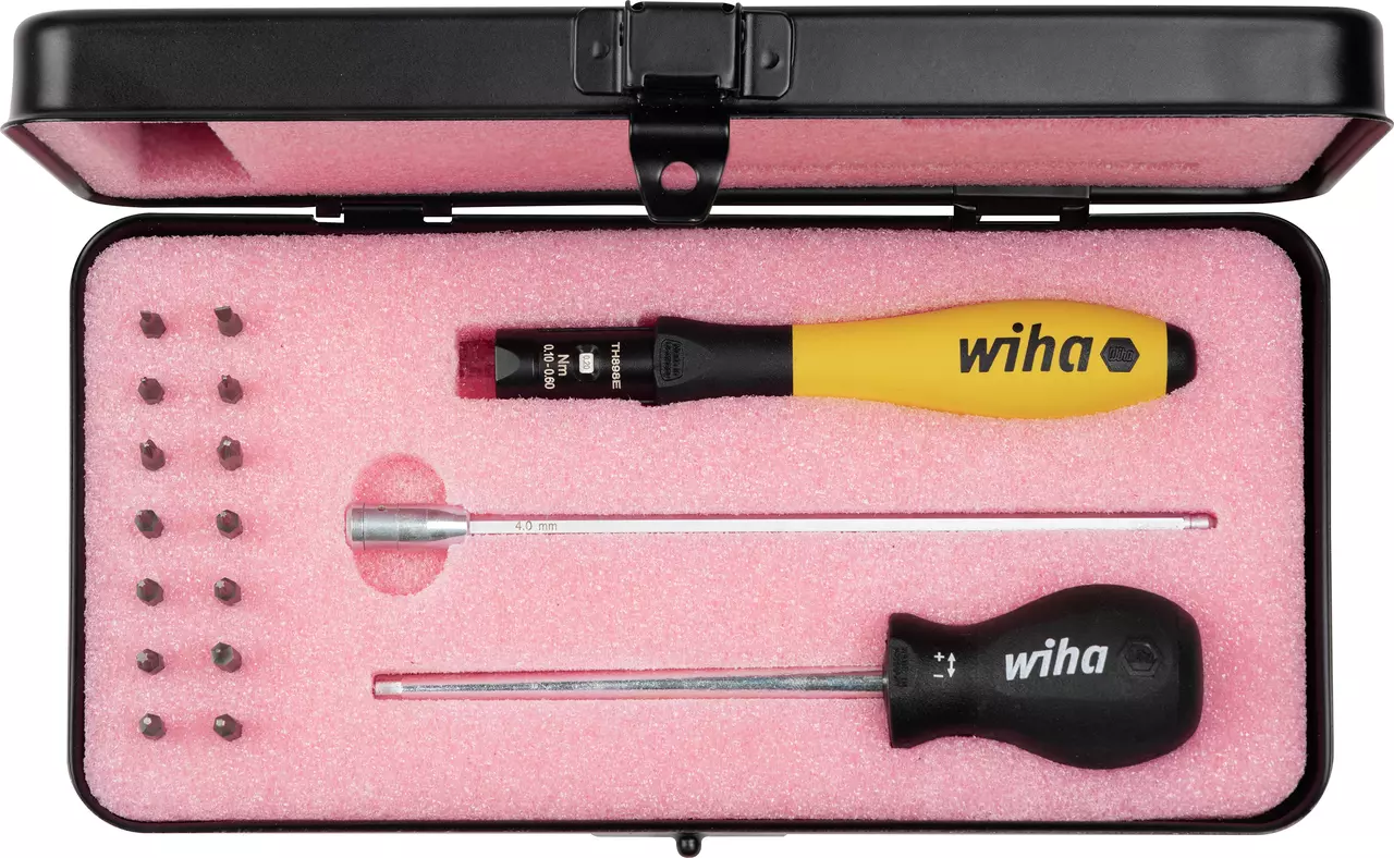 Tool set with torque handle, bits, and screwdrivers in a pink foam-lined case.