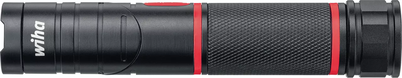 Black flashlight with textured grip and red accents