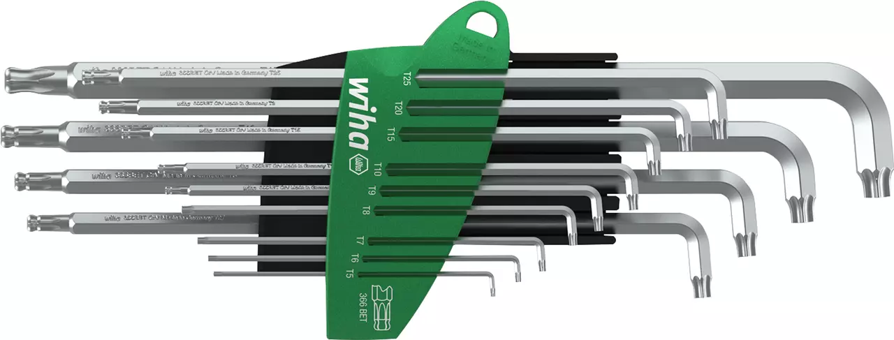 Set of L-shaped star wrenches in a green holder, different sizes visible
