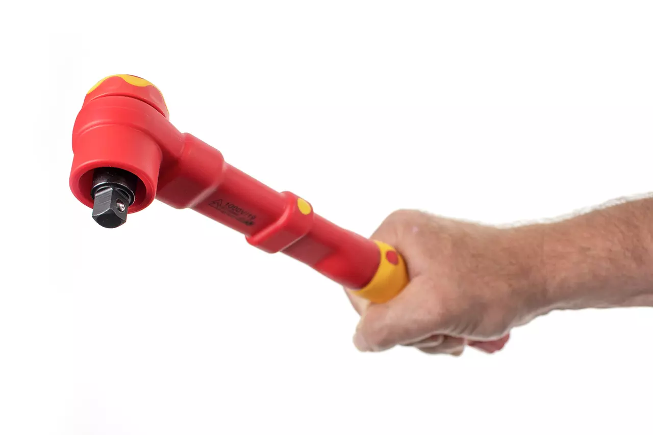 A person holding a red and yellow torque wrench against a white background.