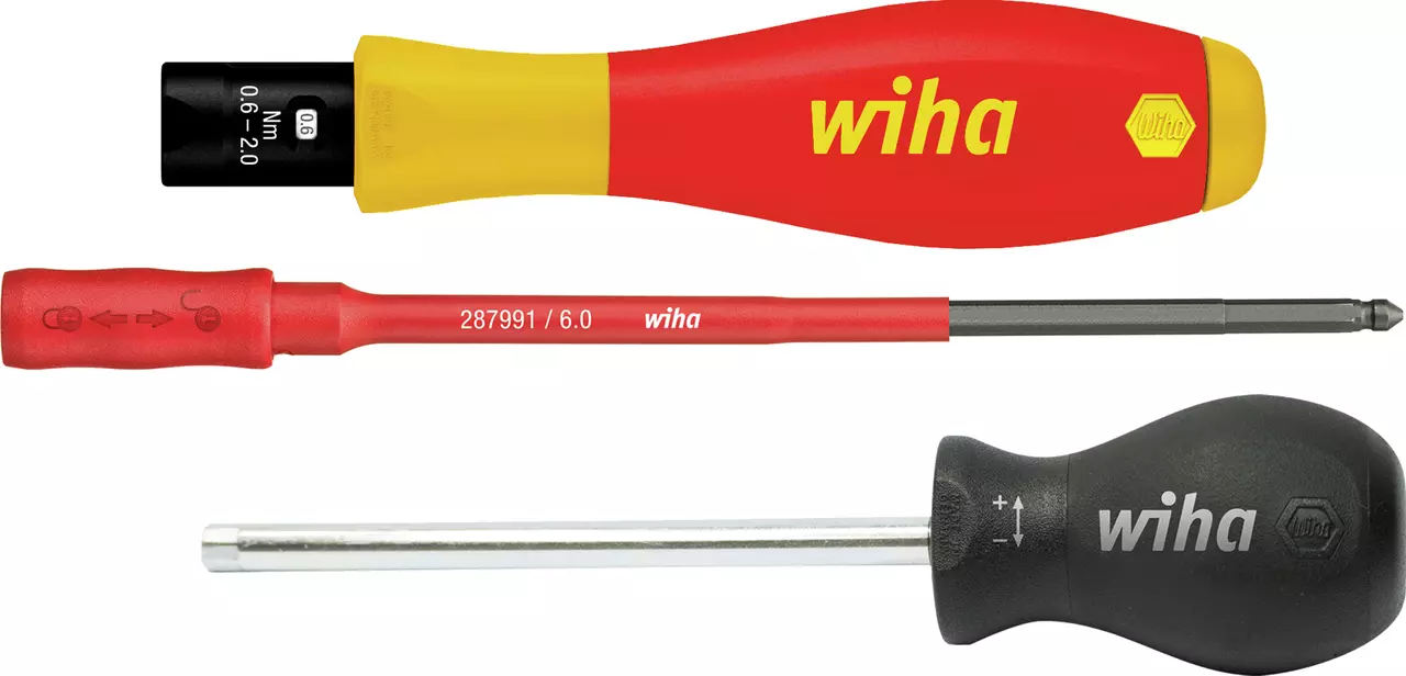 Three screwdrivers with colored handles, one red and yellow with torque settings, one red, and one black.